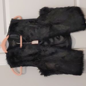 Black Faux fur vest still has tag.